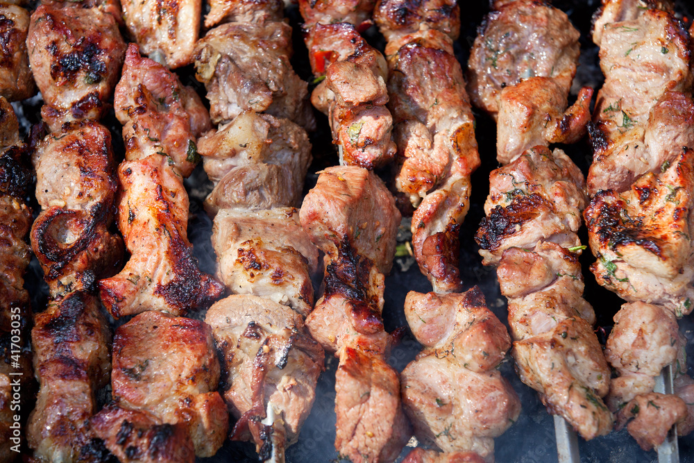 Background of grilled shish kebabs on skewers