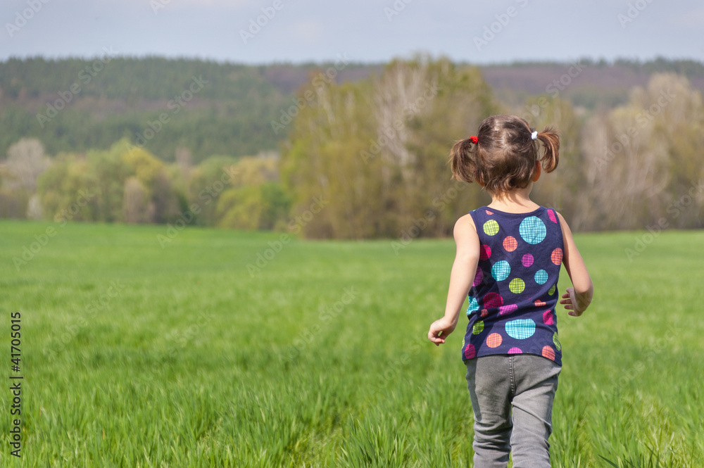 Fototapeta premium Active happy child having fun on green field