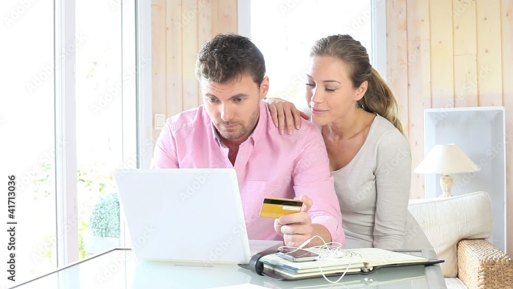 Couple shopping on internet at home Couple shopping on internet at home