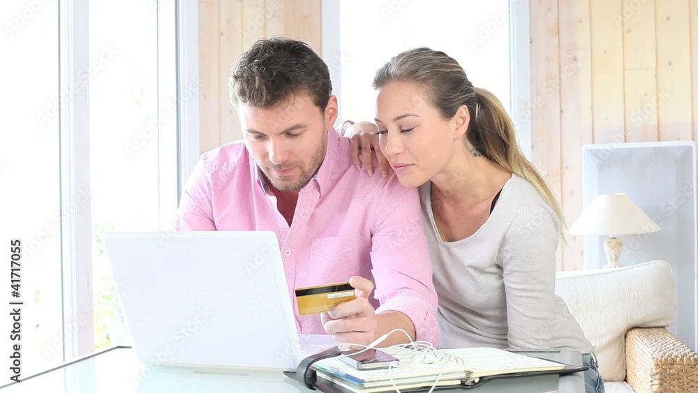 Couple shopping on internet at home Couple shopping on internet at home
