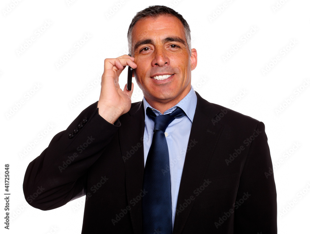 Charismatic businessman speaking on cellphone Charismatic businessman speaking on cellphone