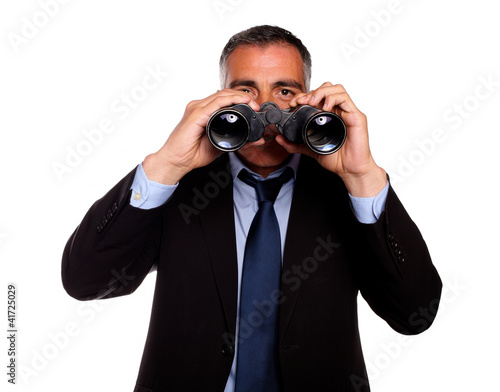 Senior man looking through binoculars