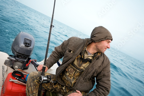 фотографія Fisherman fishing a salmon trolling