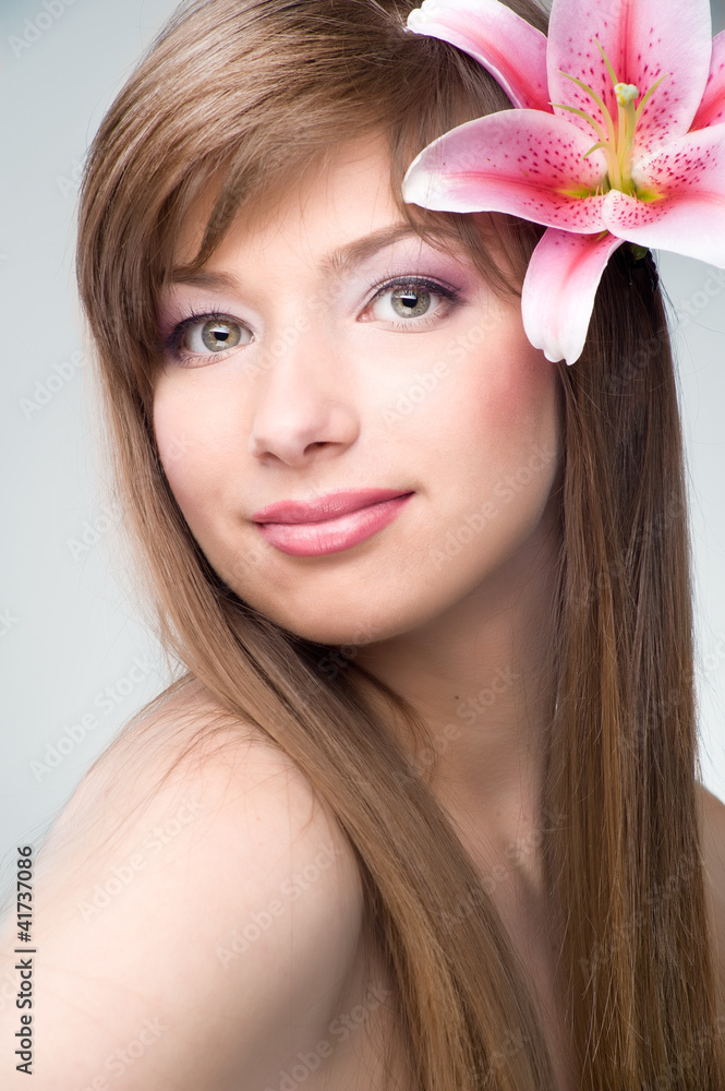 Young girl holding flower in her hands Young girl holding flower in her hands