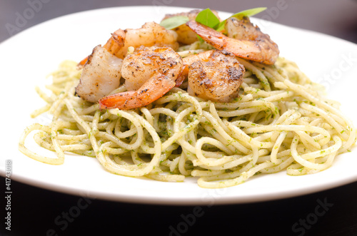 plate of spaghetti broccoli pesto and prawn ready for serving