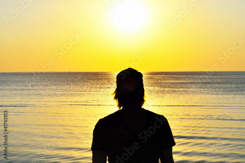 Silhouette of man enjoying sunset