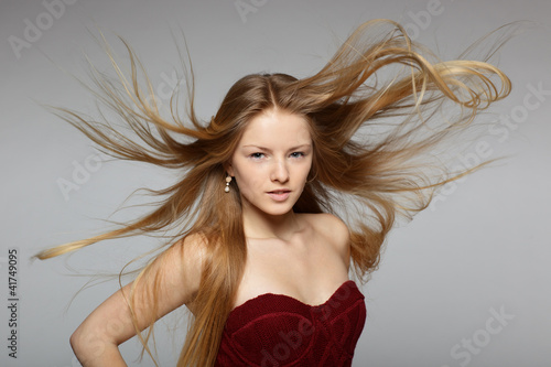 Fashion model posing with hair fluttering in the wind