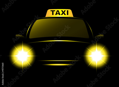 Dark cab silhouette with taxi sign and bright beams