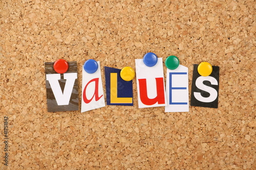 The word values in letters pinned to a cork board photo