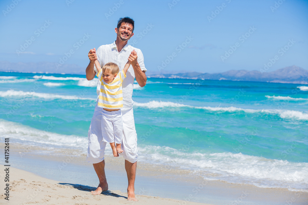Father and son having fun on beach Father and son having fun on beach