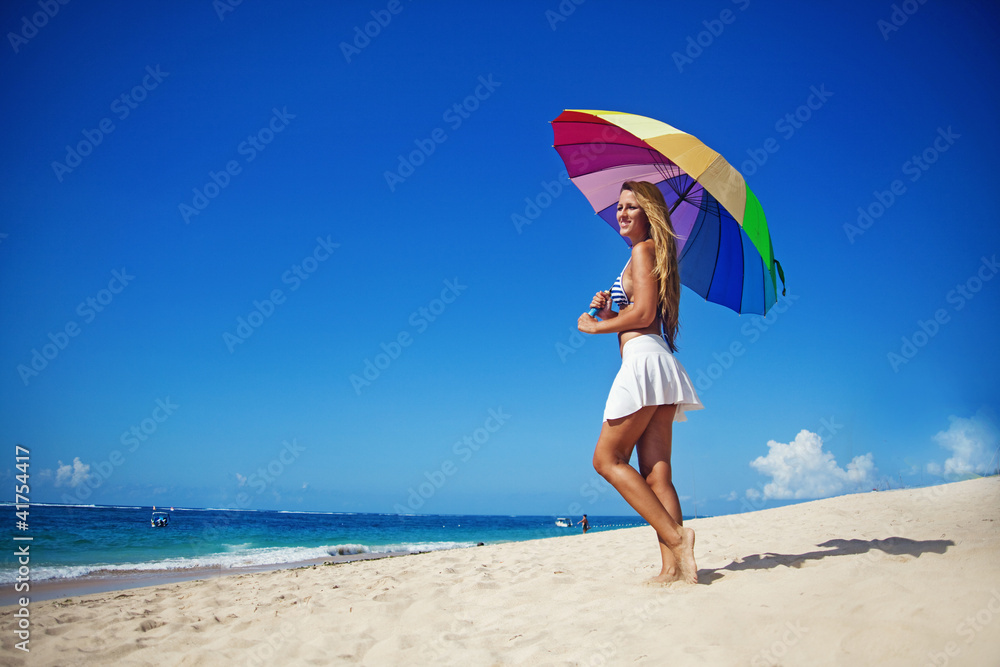 Beautiful woman with umbrella on beach, bali Beautiful woman with umbrella on beach, bali