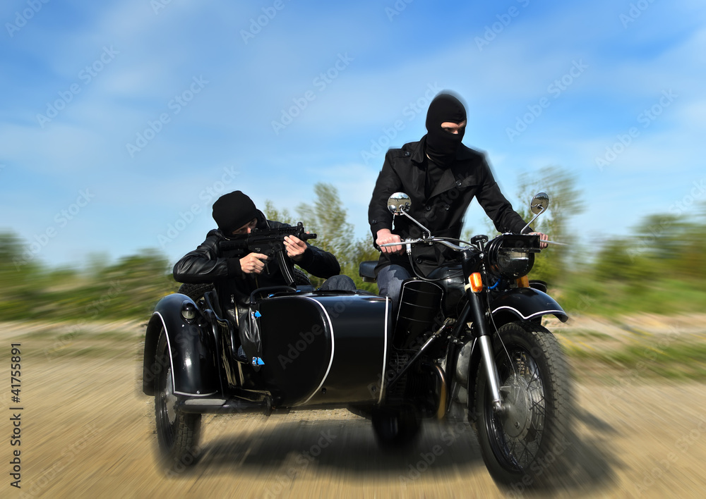 Two armed men riding a motorcycle with a sidecar. Motion blur. Stock ...