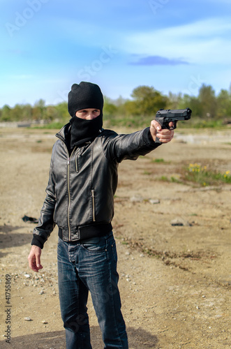 Принти на полотні Masked gunman taking aim with a gun