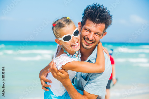Father and daughter having fun on beach © Max Topchii