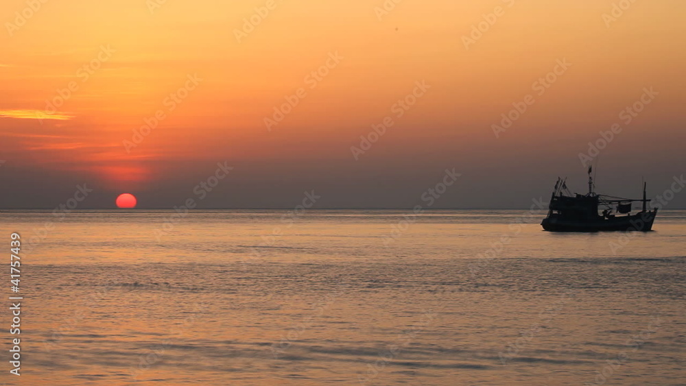 Tropical sunset with fishing ship on horizon Tropical sunset with fishing ship on horizon