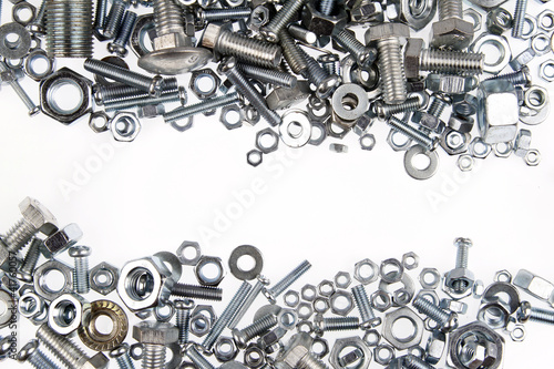 Foto Nuts and bolts on white background. Copy space