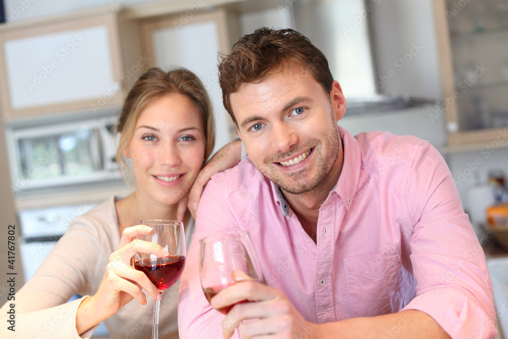 Happy couple cheering with glass of wine Happy couple cheering with glass of wine