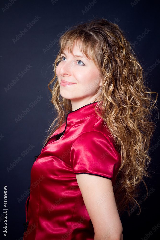 Fototapeta premium young woman with long curly hair look up