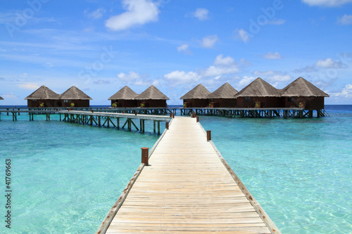 Fototapeta Naklejka Na Ścianę i Meble -  Long wooden bridge and water villas,Maldives