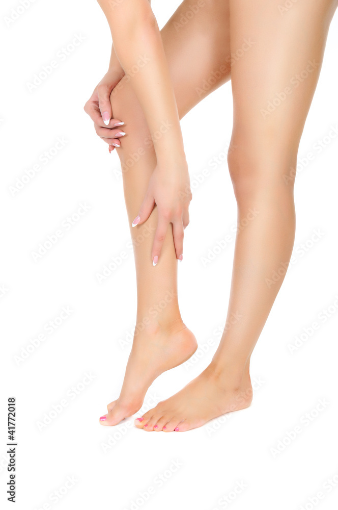 female legs being massaged with hands over white female legs being massaged with hands over white