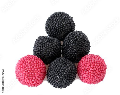 red and black candy berries isolated on white