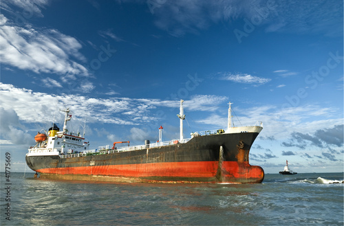 Cargo ship run aground on rocky shore shore