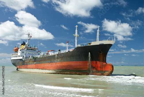 Cargo ship run aground on rocky shore