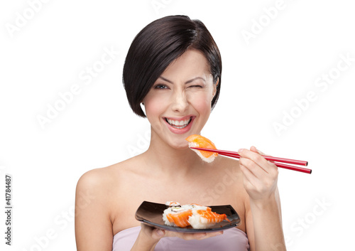 Beautiful woman eating sushi