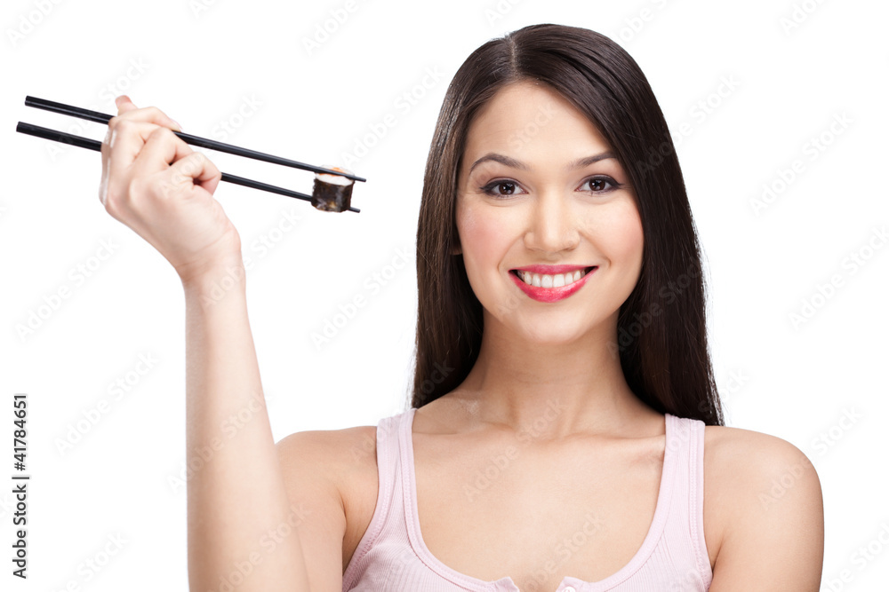 Smiling woman holding sushi roll with a chopsticks Smiling woman holding sushi roll with a chopsticks