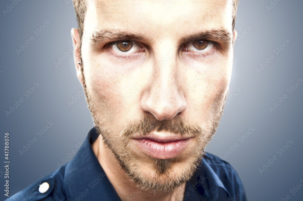 Fototapeta premium portrait of a young beautiful man, serious face expression