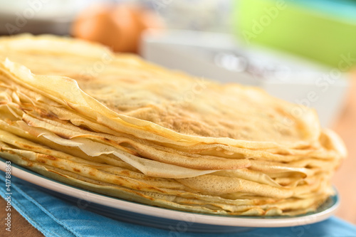 Fresh homemade crepes piled on plate (Selective Focus)