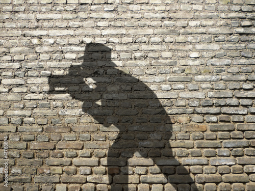 Obraz na płótnie ombre de photographe sur mur en briques w salonie