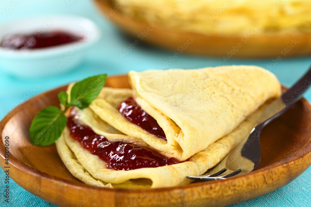 Fresh homemade crepe filled with strawberry jam