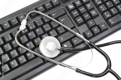 Keyboard for PC and elements for a stethoscope. On a white backg