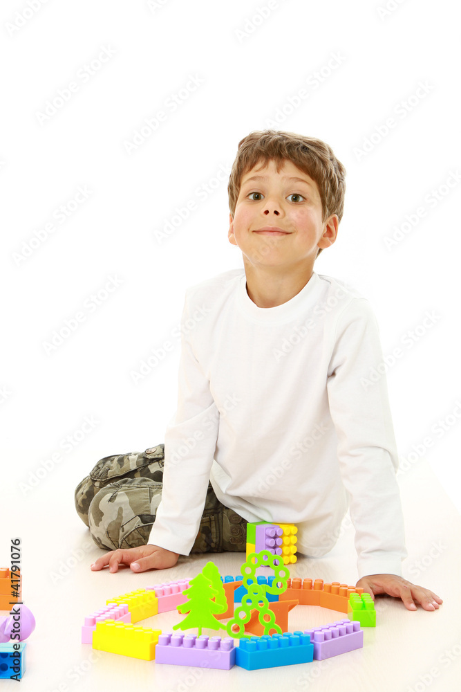 Little boy playing with toy. Isolated on white background Little boy playing with toy. Isolated on white background