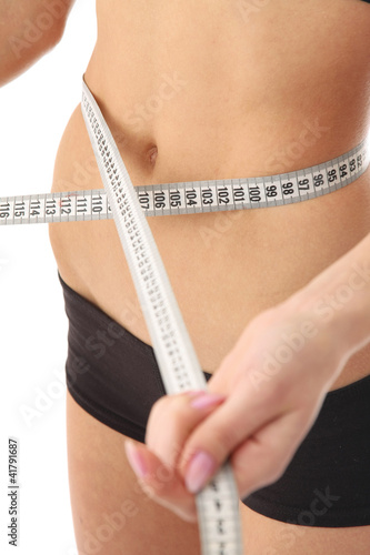 A woman measuring her waist