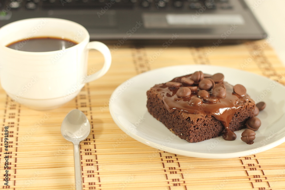 chocolate cake and a coffeecup lab top chocolate cake and a coffeecup lab top