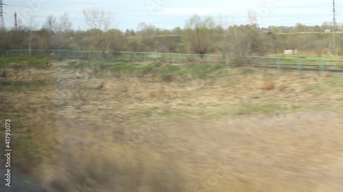 View from high-speed train window on the fields in spring photo