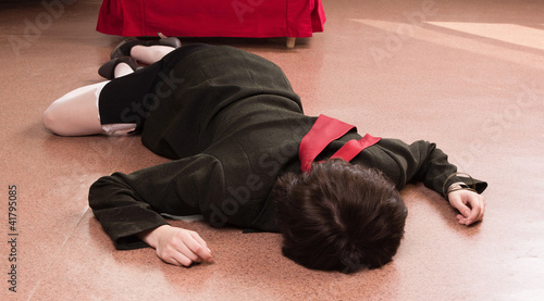 Business woman lying on the floor. Crime scene simulation © Demian