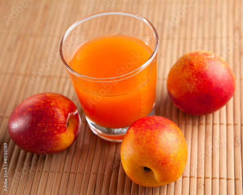 fresh juice in a glass and peaches