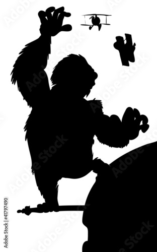 Silhouette King Kong hanging on a skyscraper