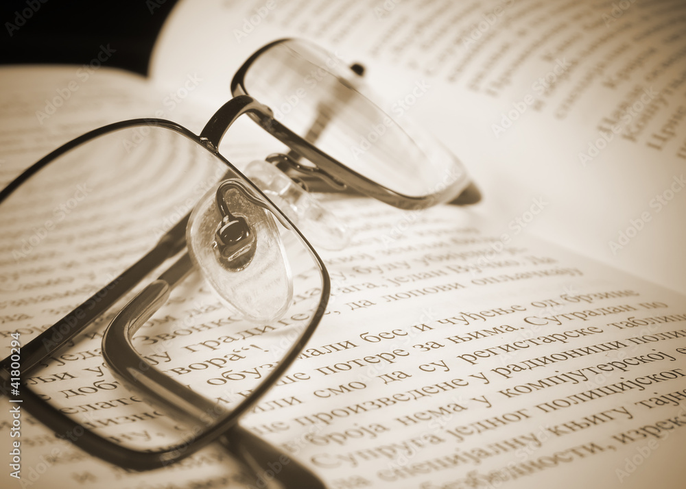 Eyeglasses on the old thick book. Eyeglasses on the old thick book.