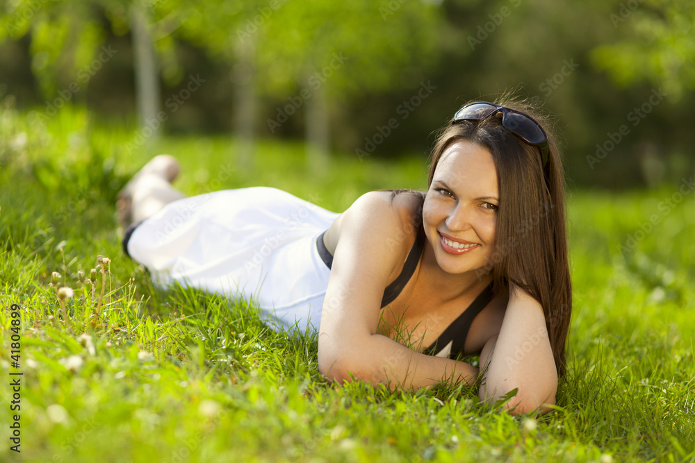Beautiful young woman relaxing in a park Beautiful young woman relaxing in a park