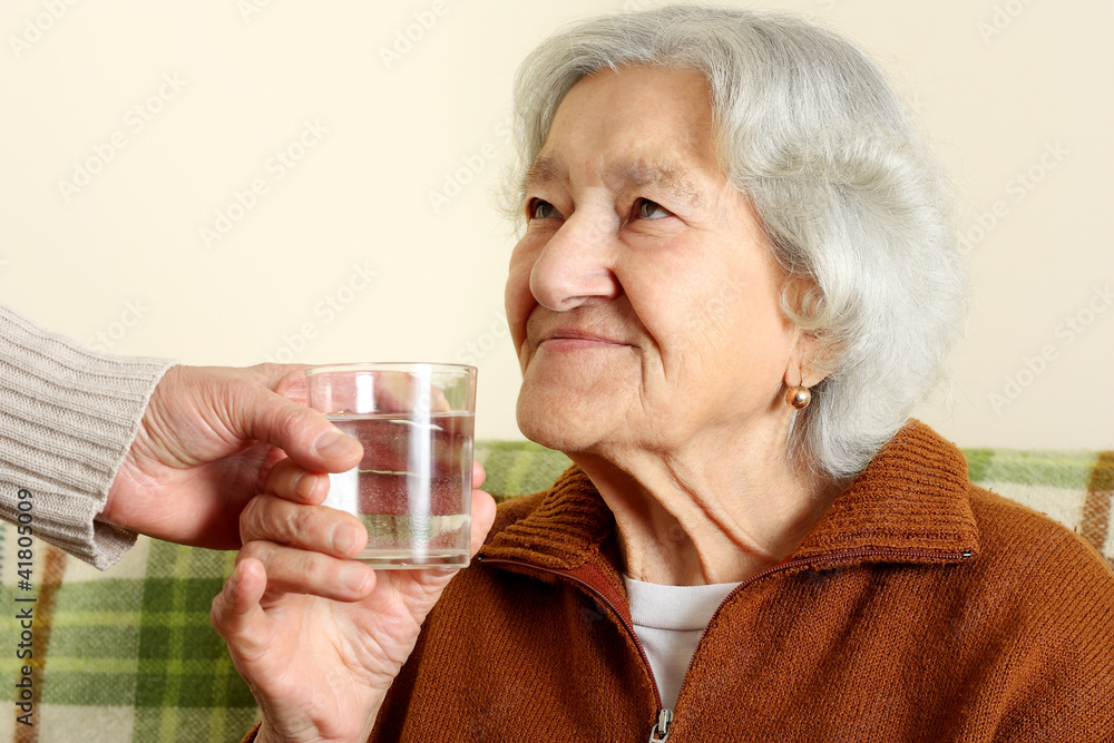 Grandmother drinks a glass water Grandmother drinks a glass water