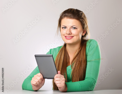 Young woman sitting on the desk with computer plane-table