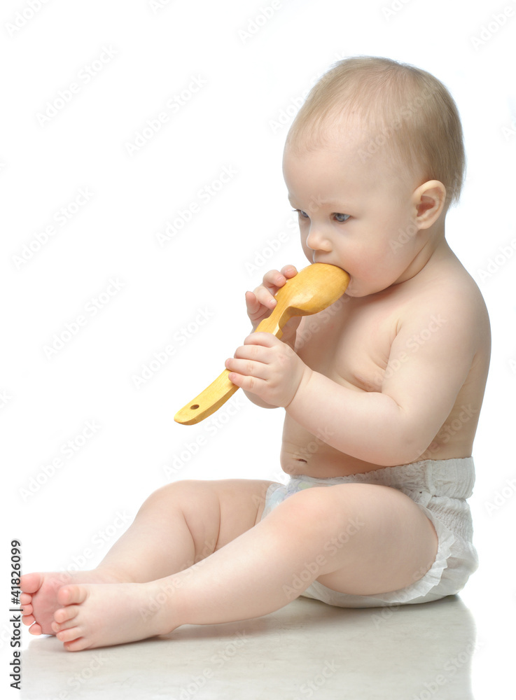 Toddler in diaper playing with wodden spoon Toddler in diaper playing with wodden spoon