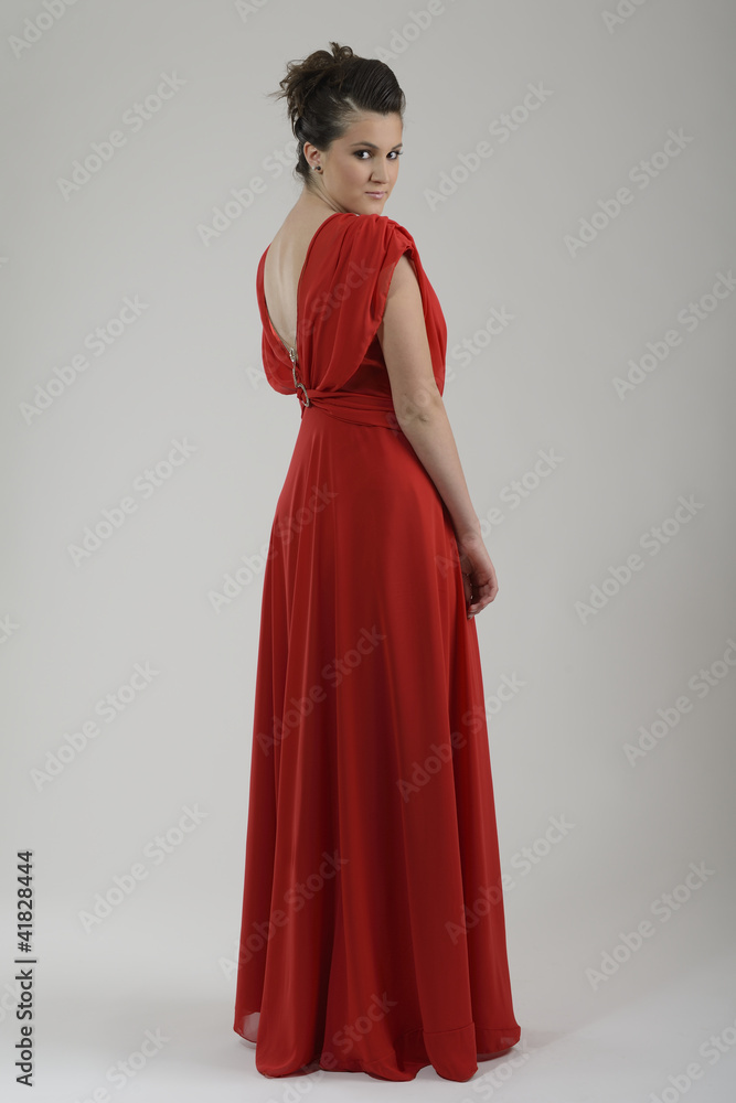 elegant woman in fashionable dress posing in the studio