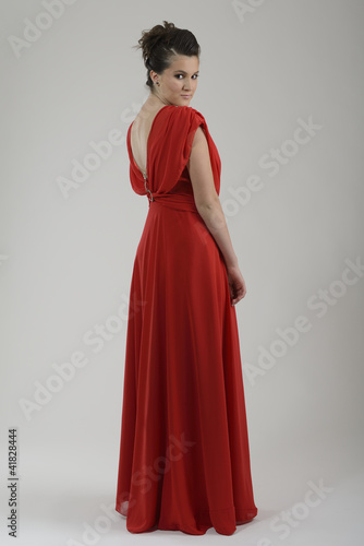 elegant woman in fashionable dress posing in the studio