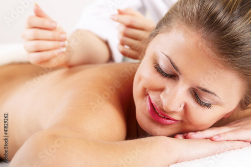 Closeup of an attractive young woman receiving massage