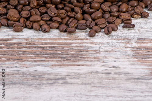 Coffee beans on vintage wood background
